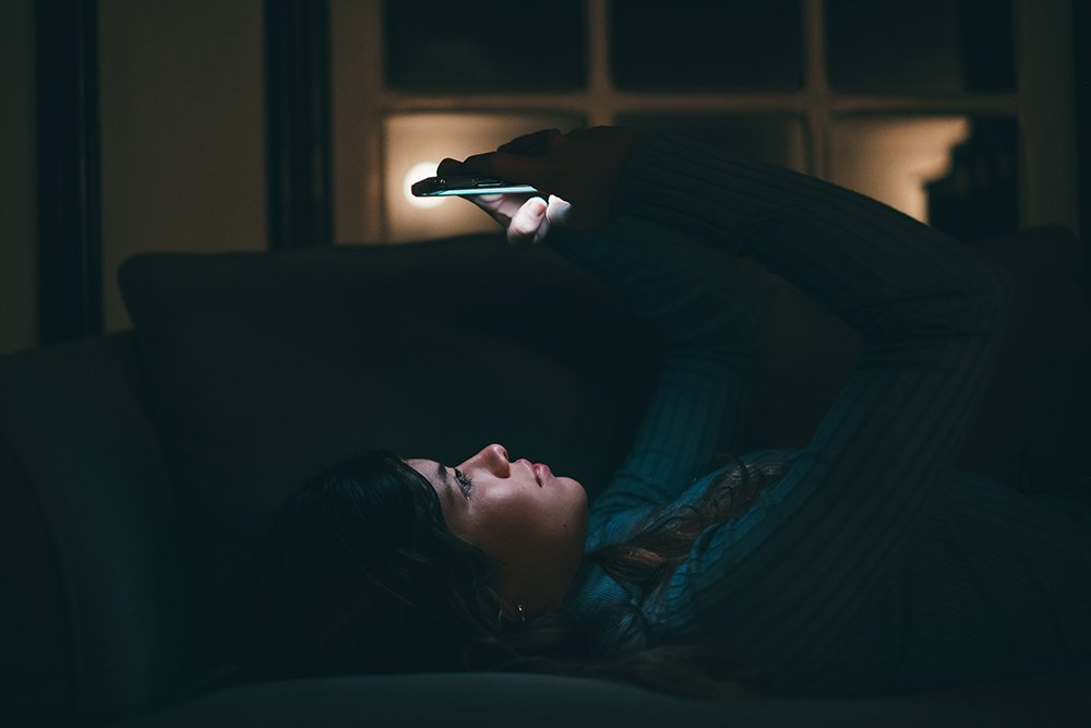 woman using phone late at night