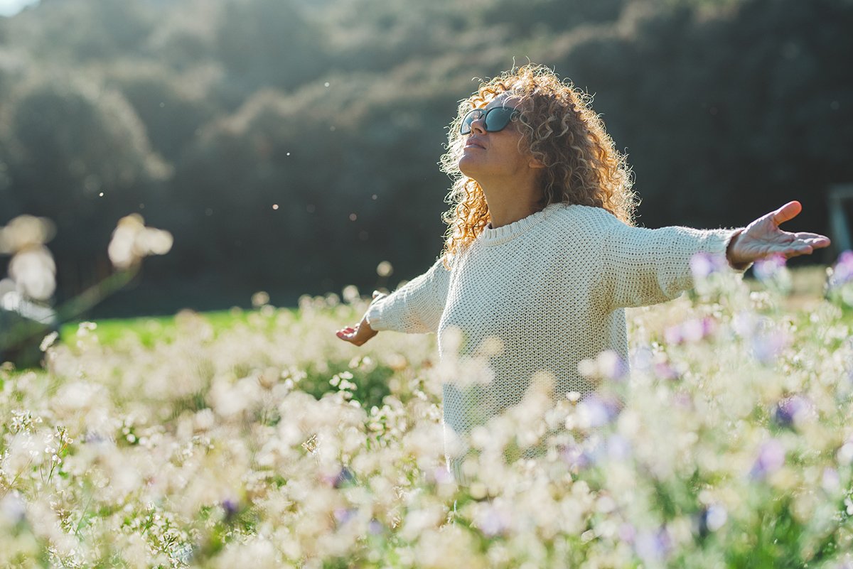 healthy woman in field of flowers
